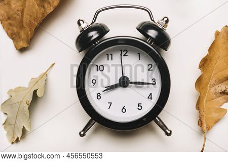 Background Of Round  Black Alarm Digital Clock With White Back Wall And Twelve Digits