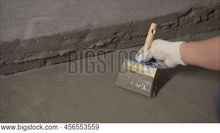 The Process Of Applying Mortar - Waterproofing To A Concrete Floor. The Concept Of Waterproofing The