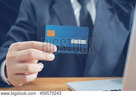 Online payment, Man's Hands holding credit card and using laptop, online credit card payment for pur