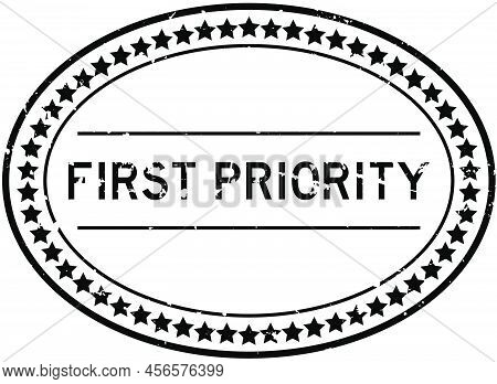 Grunge Black First Priority Word Oval Rubber Seal Stamp On White Background