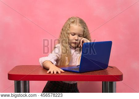 Sad, Brooding Schoolgirl Behind The Lepton. Pink Background.