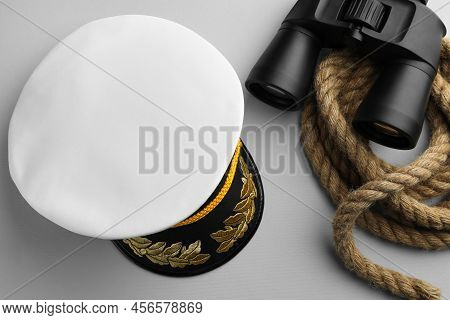 Peaked Cap, Rope And Binoculars On Light Grey Background, Flat Lay