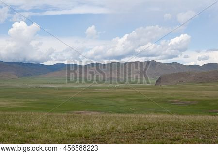 Awesome Landscape In Central Mongolia.  In The Distance, Ger Or Yurta, Traditional Mongolian Tents. 