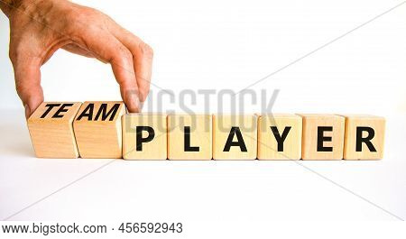 Player Or Teamplayer Symbol. Businessman Turns Wooden Cubes And Changes Concept Words Player To Team