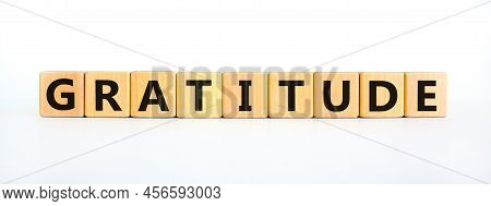Gratitude Symbol. The Concept Word Gratitude On Wooden Cubes. Beautiful White Table, White Backgroun