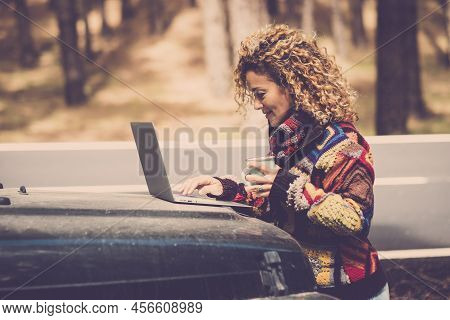 Adult Woman Work Outdoor With Laptop Computer In The Outdoors Nature With Roaming Technology - Digit