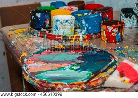 Bright Spots Of Paint And Jars In The Art Workshop