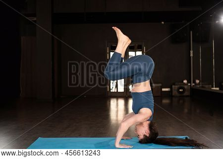 Side View Of Hispanic Woman Doing Yoga Exercise At Gym, Yoga Forearm Stand Pose Or Pincha Mayurasana