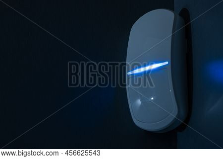 Modern Motion Sensor In Action In A Dark Room.