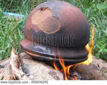 Camping Outside Cooked With Terracotta Cap With Smokey Flavor.