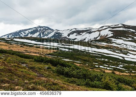 Snow Mountain Tops, Mountain Trail And Bushes