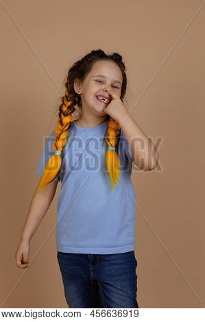Caucasian Naughty Small Girl Smiling Shining Picking Nose With Finger Looking At Camera Having Kanek