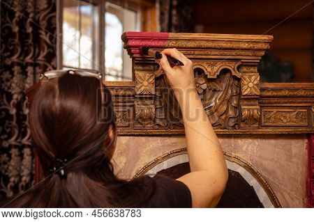Lady In The Beginning Of Restoring Carved Ornaments Of Antique Cupboard For Kitchen With Window In B