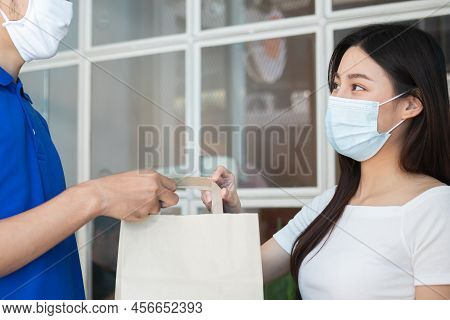 Young Asian Woman, Customer Wearing Face Mask Protect To Pandemic Of Covid And Received Bag,cardboar
