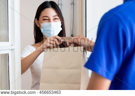Young Asian Woman, Customer Wearing Face Mask Protect To Pandemic Of Covid And Received Bag,cardboar