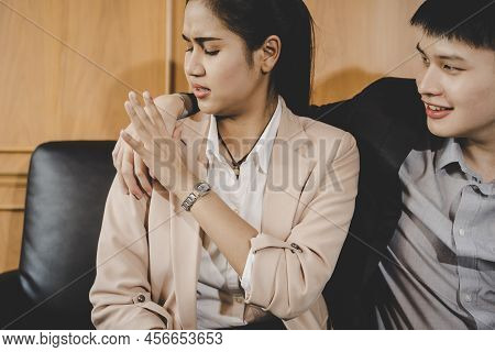 Unhappy Asian Young Employee, Employer  Looking At Hand Of Colleagues, Boss Touching At Her Shoulder