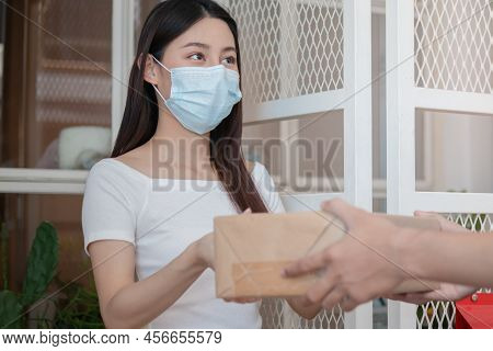 Asian Young Woman, Client Received A Delivery Of Cardboard Box, Parcel From Delivery, Postman, Weari