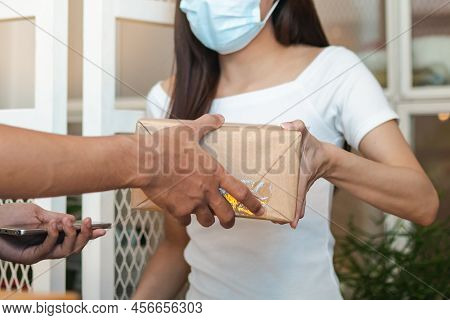 Young Asian Woman, Client Received A Delivery Of Cardboard Box, Parcel From Delivery, Postman, Weari