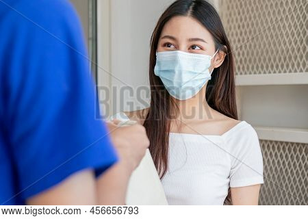 Young Asian Woman, Customer Wearing Face Mask Protect To Pandemic Of Covid And Received Bag,cardboar