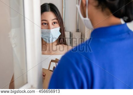 Young Asian Woman, Customer Wearing Face Mask Protect To Pandemic Of Covid And Received Bag,cardboar
