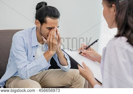 Young Asian Man, Male Has Mental Symptoms Which Must Have Been Therapy And Stress, Sitting On Couch 
