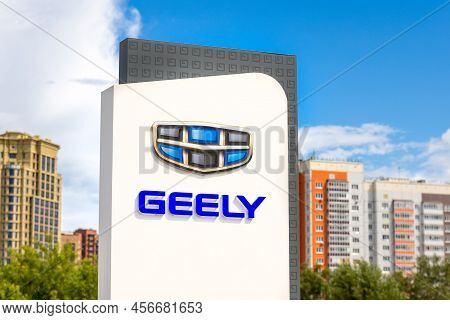 Krasnoyarsk, Russia - June 19, 2022: Geely Brand Logo Near Dealership Store Of Car Shop. Geely Autom