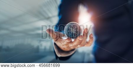 Businessman Hand Holding Compass Navigating Business Direction And Successful Strategic Solution.ref