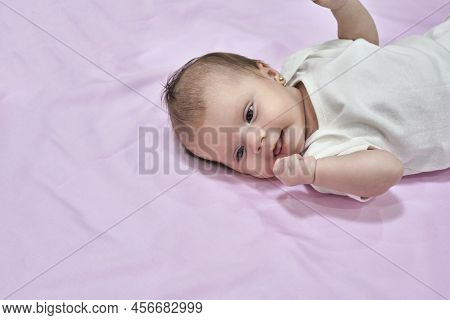 Newborn Baby Girl Sleep On Pink Blan. Close Up