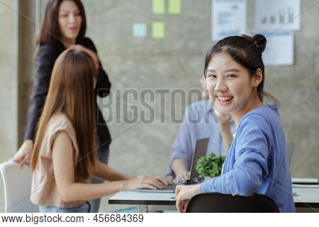Asian Teenage Women Sit In A Startup Company Meeting Room, Young Generation Co-found And Develop A P
