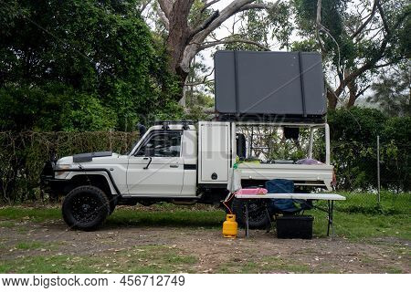 Bendalong, Australia 2021-12-22 Ute Pick Up Vehicle With Rooftop Tent Camping On A Campsite. Minimal