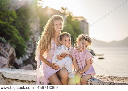 Mother And Two Children Daughter And Son Tourists On Background Of Beautiful View St. Stephen Island