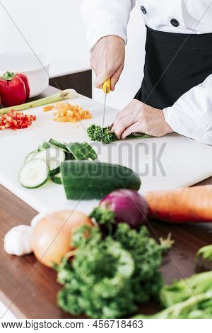 Hands Of Female Chef Cutting Vegetables, Chef Hands Preparing And Cutting Vegetables, Close Up Of A