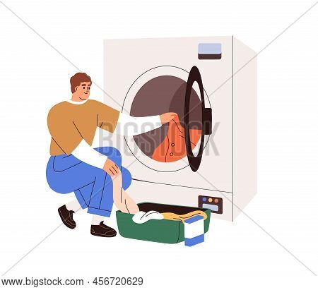 Man Loading Washing Machine With Dirty Clothes. Person Putting Linen Into Washers Drum. Guy Opening 