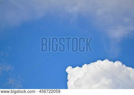 A White Cloud Against A Bright Blue Sky.