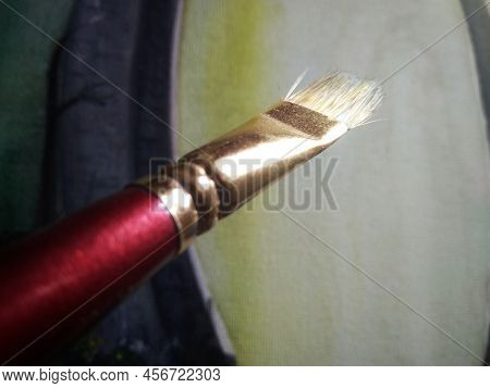 Artists Brushes Or Painting Brushes With Painting In Blurred Background.