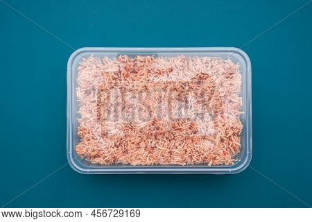 A Box Of Sweet And Sour Crispy Noodles (or Mee Krob In The Thai Language) On A Blue Light Background