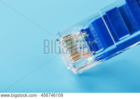 Ethernet Cable Connector Patch Cord Cord Close-up On A Blue Background With Free Space