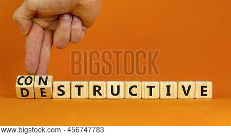Destructive Or Constructive Symbol. Businessman Turns Cubes Changes The Concept Word Destructive To 
