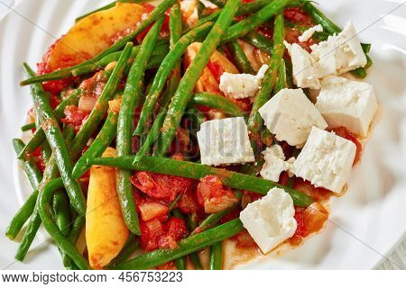 Fasolakia Lathera, Green Beans, Onion And Potatoes Stewed In Tomato, Herbs And Olive Oil On White Pl