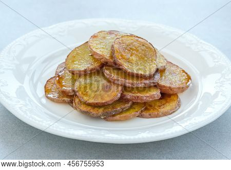 Portion Of Fried Sliced Potatoes On The Plate