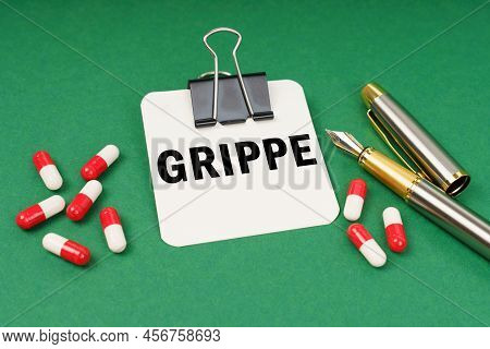 Medical Concept. On The Green Surface Of The Tablet, A Pen And A Notepad With The Inscription - Grip