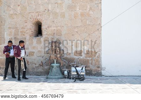 Tlacolula, Oaxaca, Mexico- May 23, 2022: Members Of Mariachi Waiting Outside Of Parroquia Santa Mari