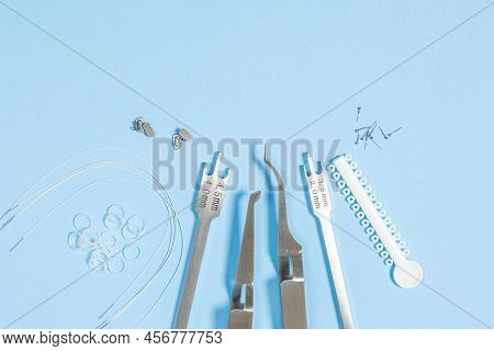 A Set Of Special Tools For An Orthodontist To Install Braces For A Patient. Orthodontic Arcs, Ligatu