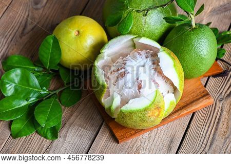 Fresh Green Pomelo Peeled And Leaf Frome Pomelo Tree , Pomelo Fruit On Wooden Plate  Background, Pum
