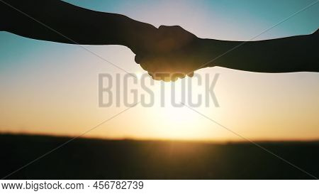 Handshake Farmers Silhouette. Agriculture Business Concept. Close-up Farmers Hands Silhouette Shakin