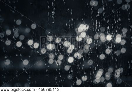 Rain Drops On The Window Of The Storm Outside But Being Cozy Inside With Christmas Light Outside In 