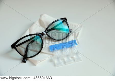 Single Dose Eye Drops, Glasses And Fabric On White Table
