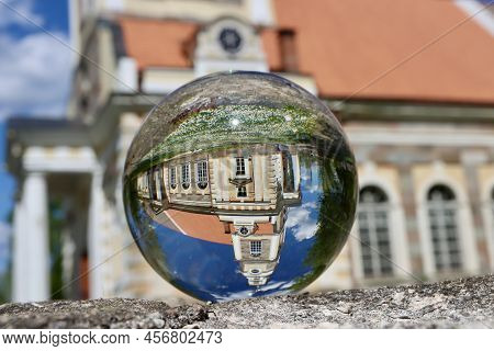 Small Lutheran Church In Aluksne Town, Latvia, Seen Through Crystal Ball