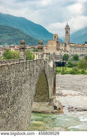 Bobbio, Italy , The Old Bridge (also Known As The Devil's Bridge) Over The Trebbia River, With The C