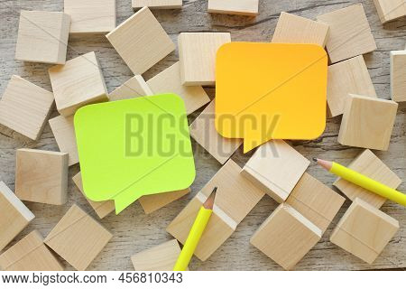 Multicolored Paper Stickers On A Wooden Table